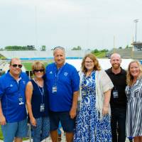A group photo in front of the field at the Jamie Hosford Football Center dedication.